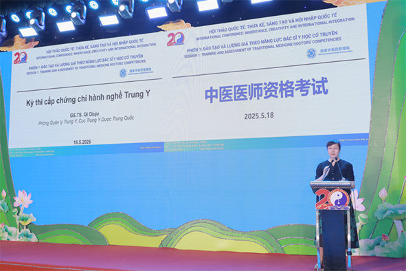 A person standing at a podium with a microphone

Description automatically generated
