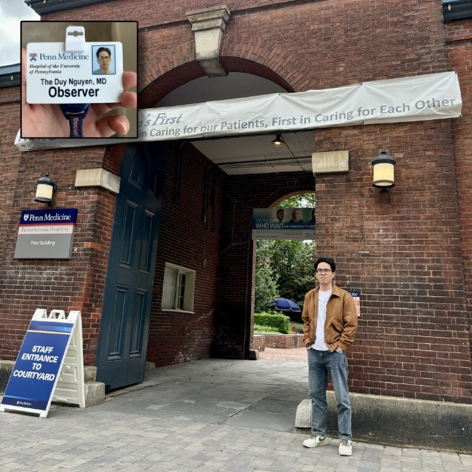 A person standing in front of a brick building

Description automatically generated